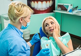 A dentist treating a woman’s dental emergency