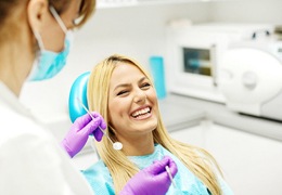Woman in dental chair smiling.