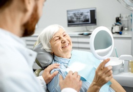 Older woman in dental chair with a healthy smile.