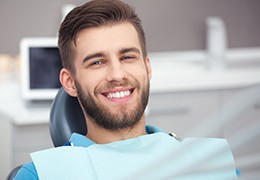 A happy, smiling man sitting in the dentist’s chair