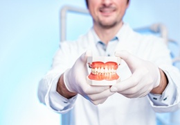 dentist holding dental mold