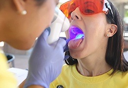 Woman receiving oral cancer screening